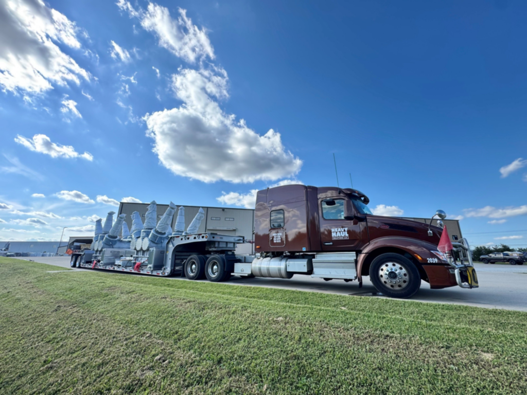 Heavy haul trucking transporting substation switchgear equipment on a multi-axle trailer.